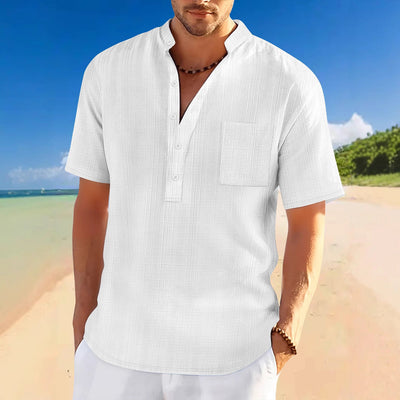 Men's full size white short sleeve half button polo shirt with slight stretch and basic style on beach background