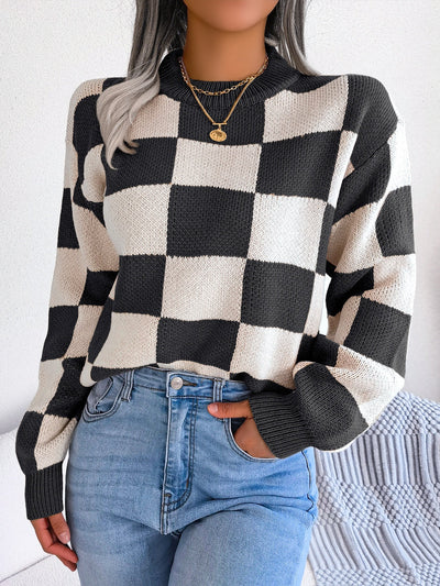 Checkered mock neck long sleeve sweater in black and white worn by model.