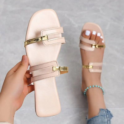 Open toe flats sandals in PU leather with gold accents and rubber sole.