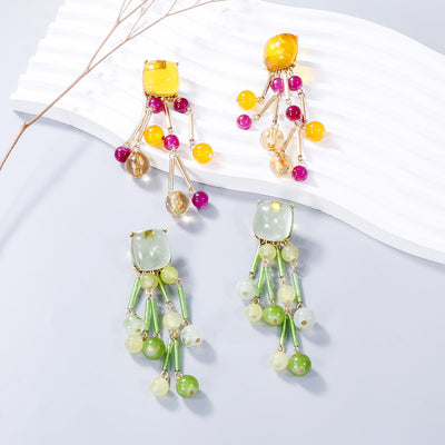 Colorful acrylic bead dangle earrings with gold accents; lightweight and stylish accessory.