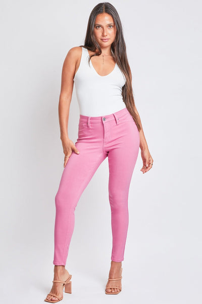 YMI Jeanswear Full Size Hyperstretch Mid-Rise Skinny Pants in pink worn by model against a neutral background.