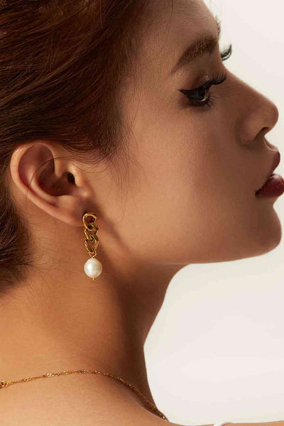 Modern stainless steel pearl earrings with 18K gold plating and freshwater pearls.