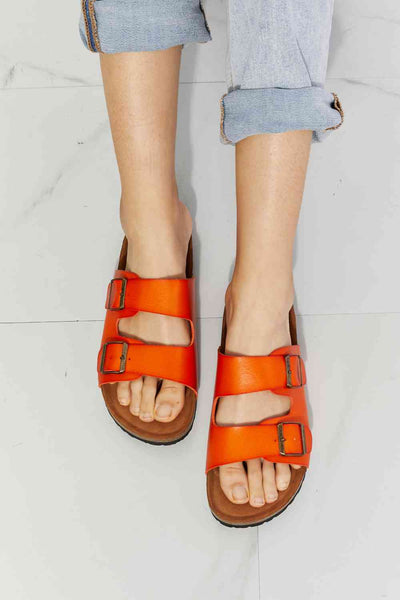 Orange buckled MMShoes double banded slide sandals with open toe and flat heel, perfect for summer.